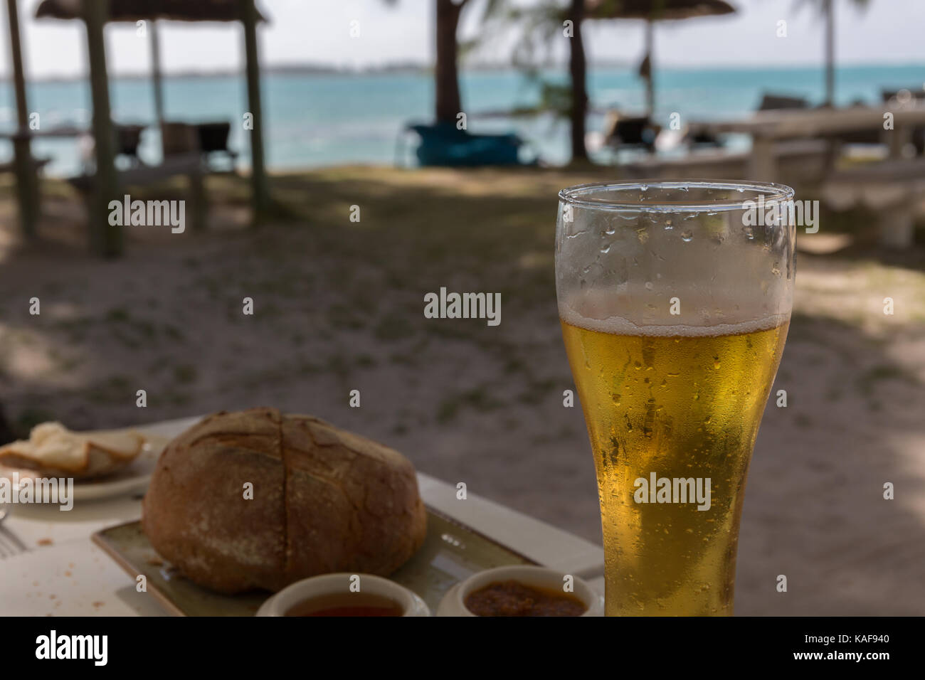 A cold beer at a beach restaurant Stock Photo