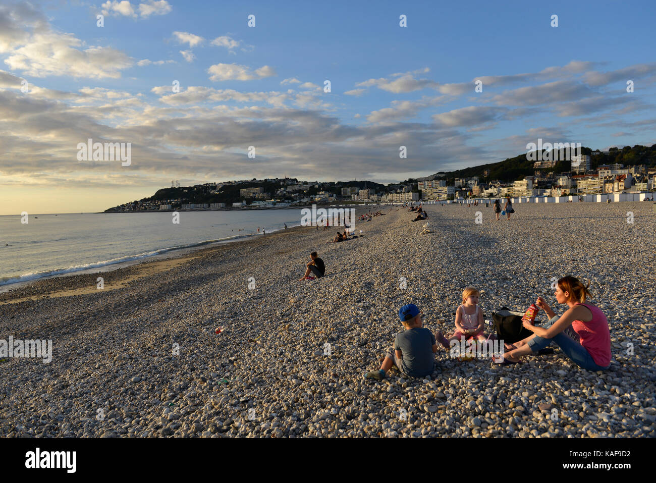 Le Havre (Normandy region, north western France): families on the pebble beach enjoying the sunset Stock Photo