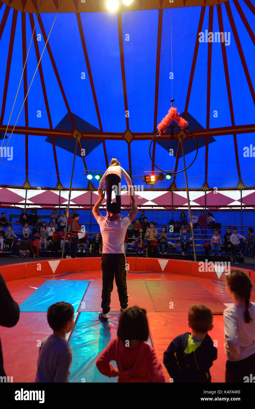 Circus class for pupils of a nursery and primary school. Tightrope walking lesson under the circus tent Stock Photo