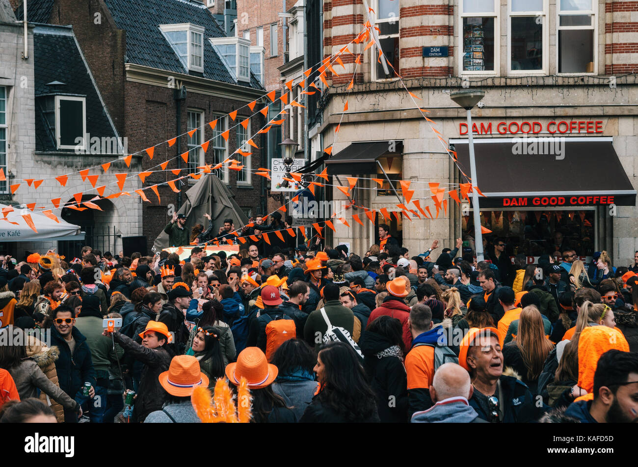 Amsterdam, Netherlands - 27 April, 2017: Streets of Amsterdam with orange decorations full of people in orange during the celebration of kings day. Stock Photo