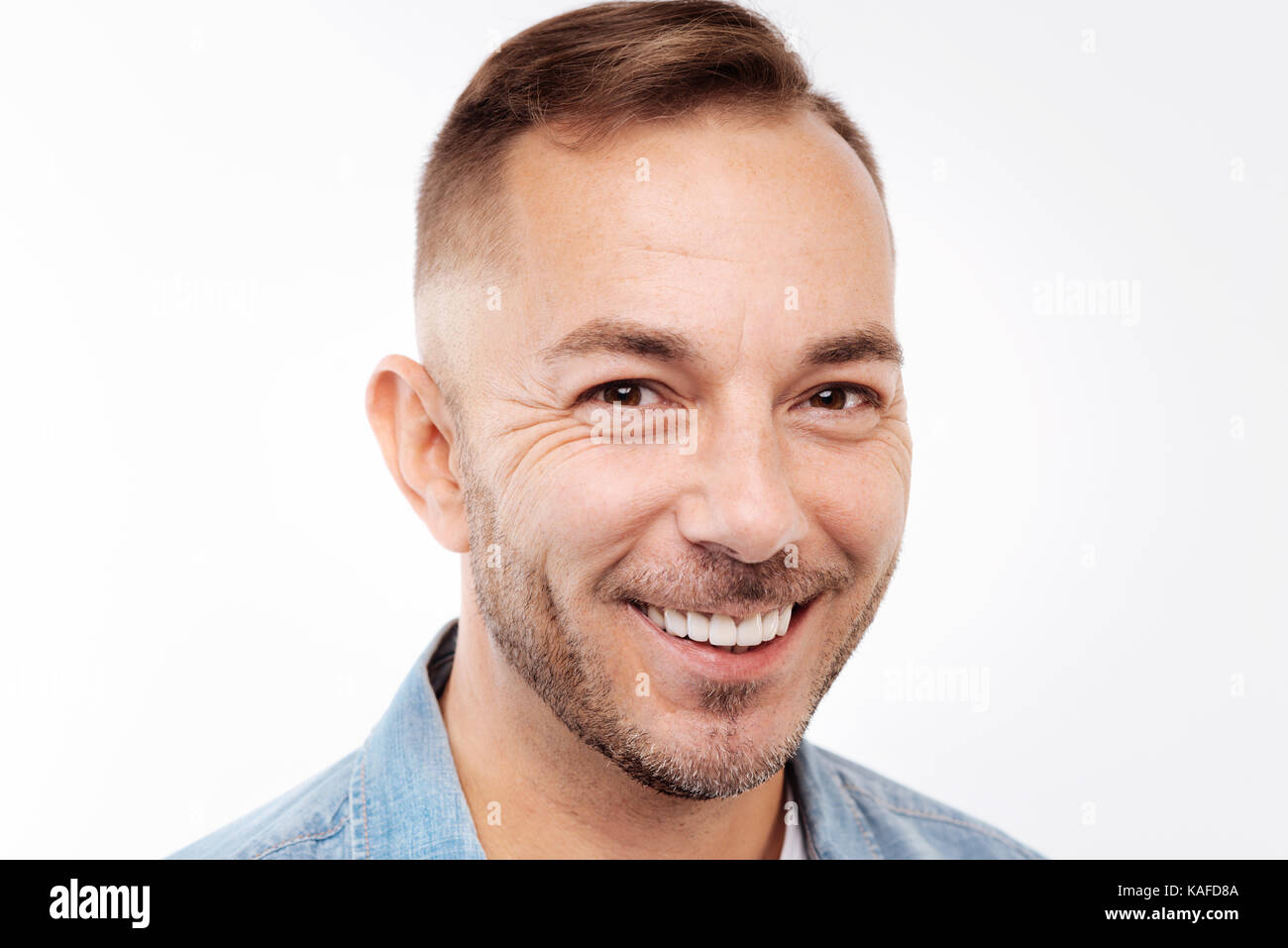 Portrait of smiling young man isolated on white background Stock Photo ...