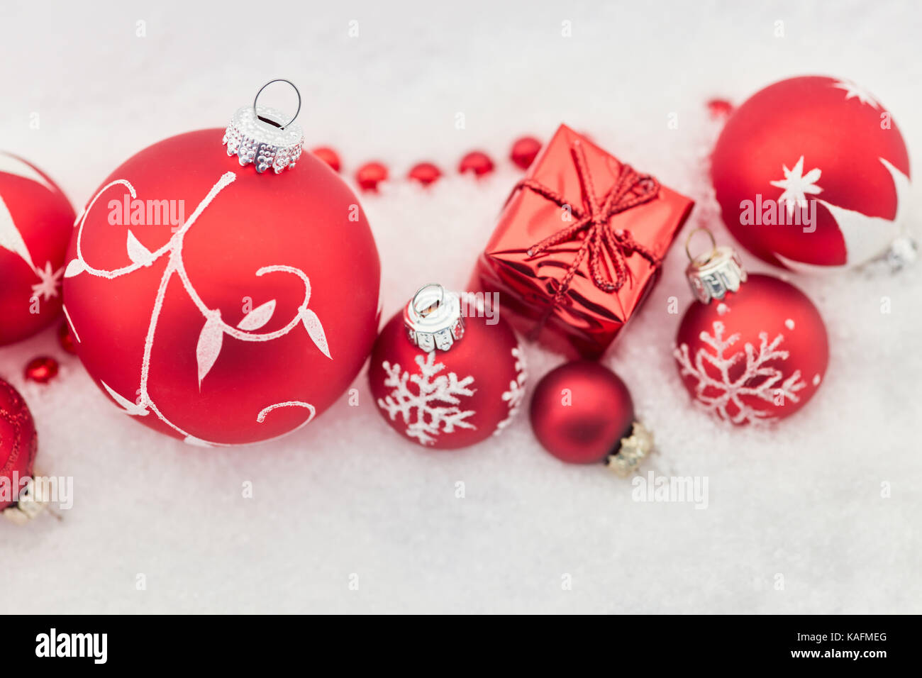 Christmas background with gift and red baubles Stock Photo - Alamy