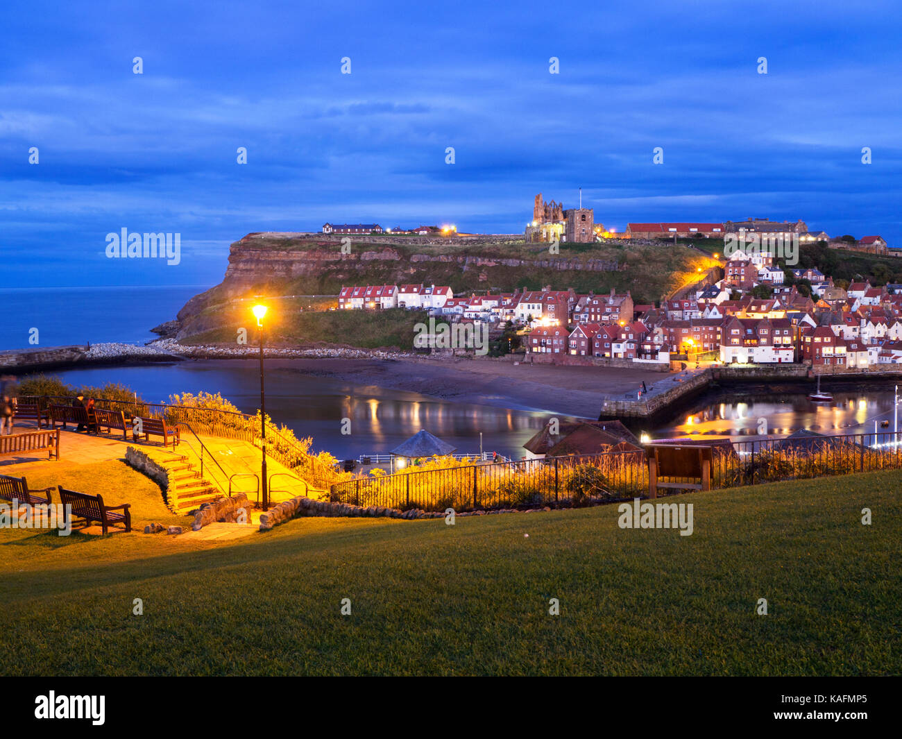 View from West Cliff to St Marys Church and Whitby Abbey at Dusk Whitby Yorkshire England Stock Photo