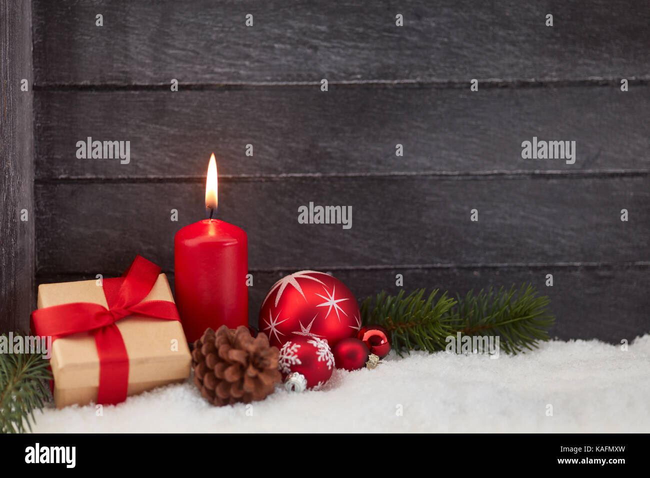 Burning candle and gift as christmas background Stock Photo - Alamy