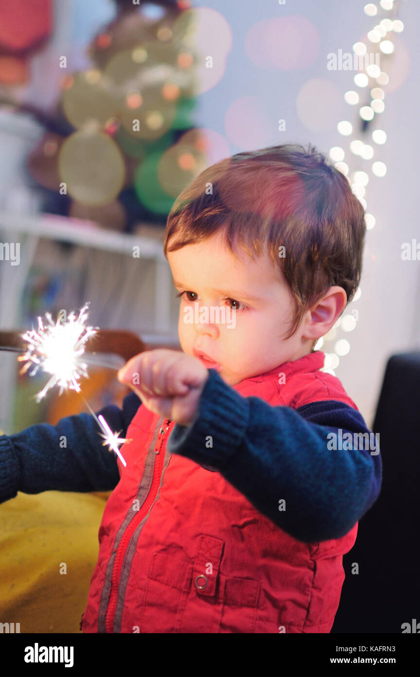 Little kid holding a sparkling stick Stock Photo
