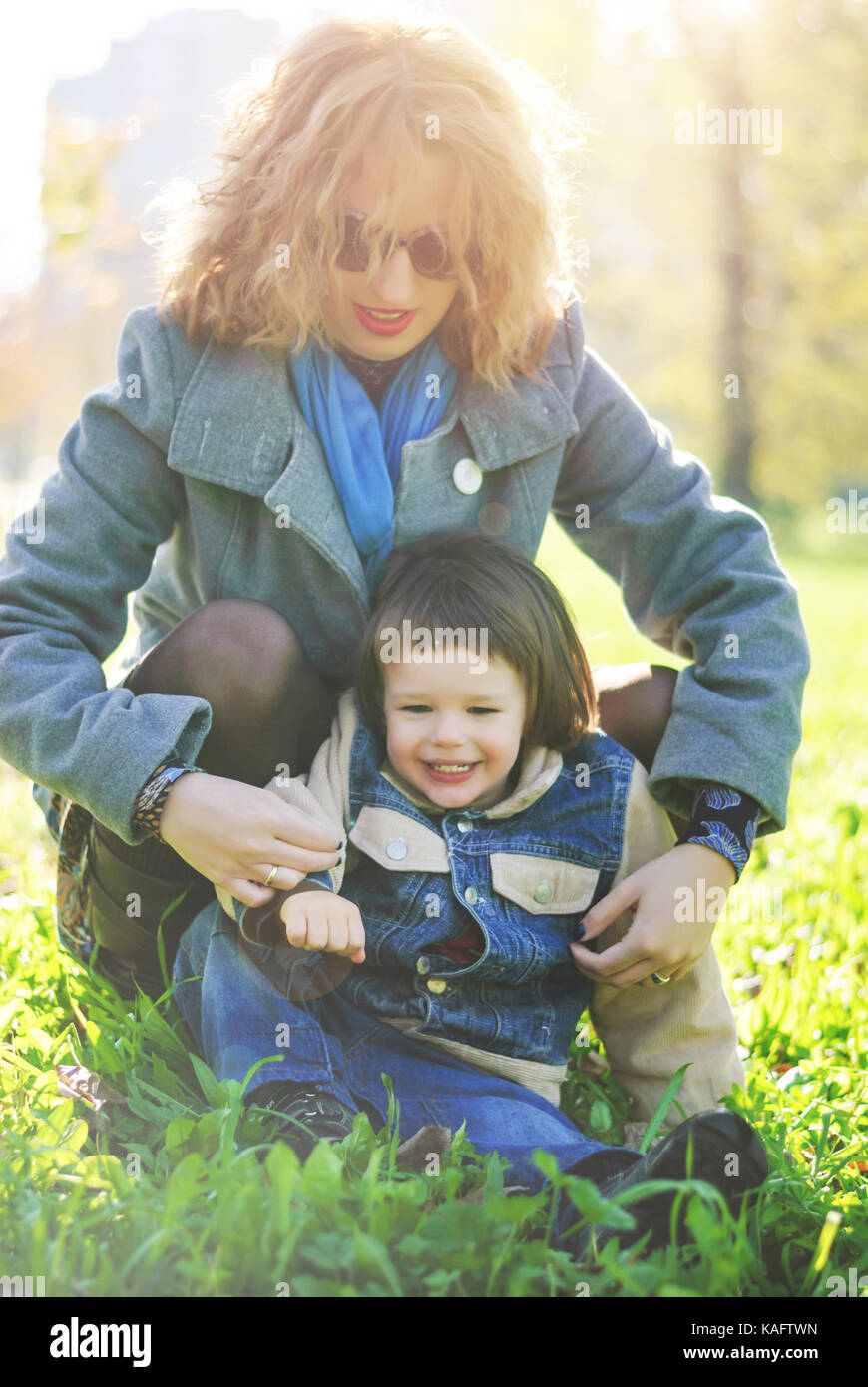 Mom and her young son playing in the park, autumn moments Stock Photo