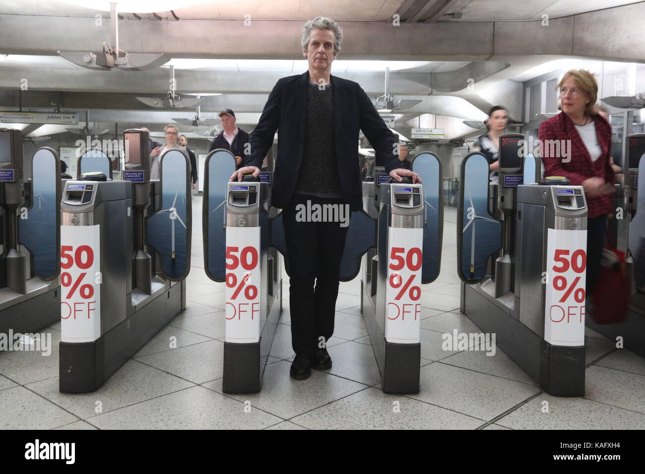 Actor Peter Capaldi at Westminster tube station where Greenpeace, WWF and the Marine Conservation Society have launched a new campaign supporting offshore wind as the future for UK energy by taking over the station, and placing posters on the walls and ticket gates with the message that electricity from offshore wind is half the price it was just two years ago. Stock Photo