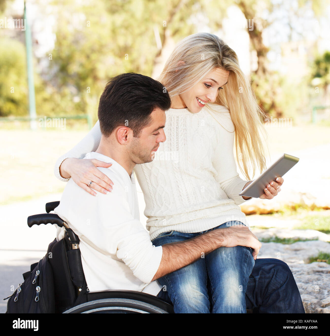 Disabled man and his girlfriend with digital tablet Stock Photo