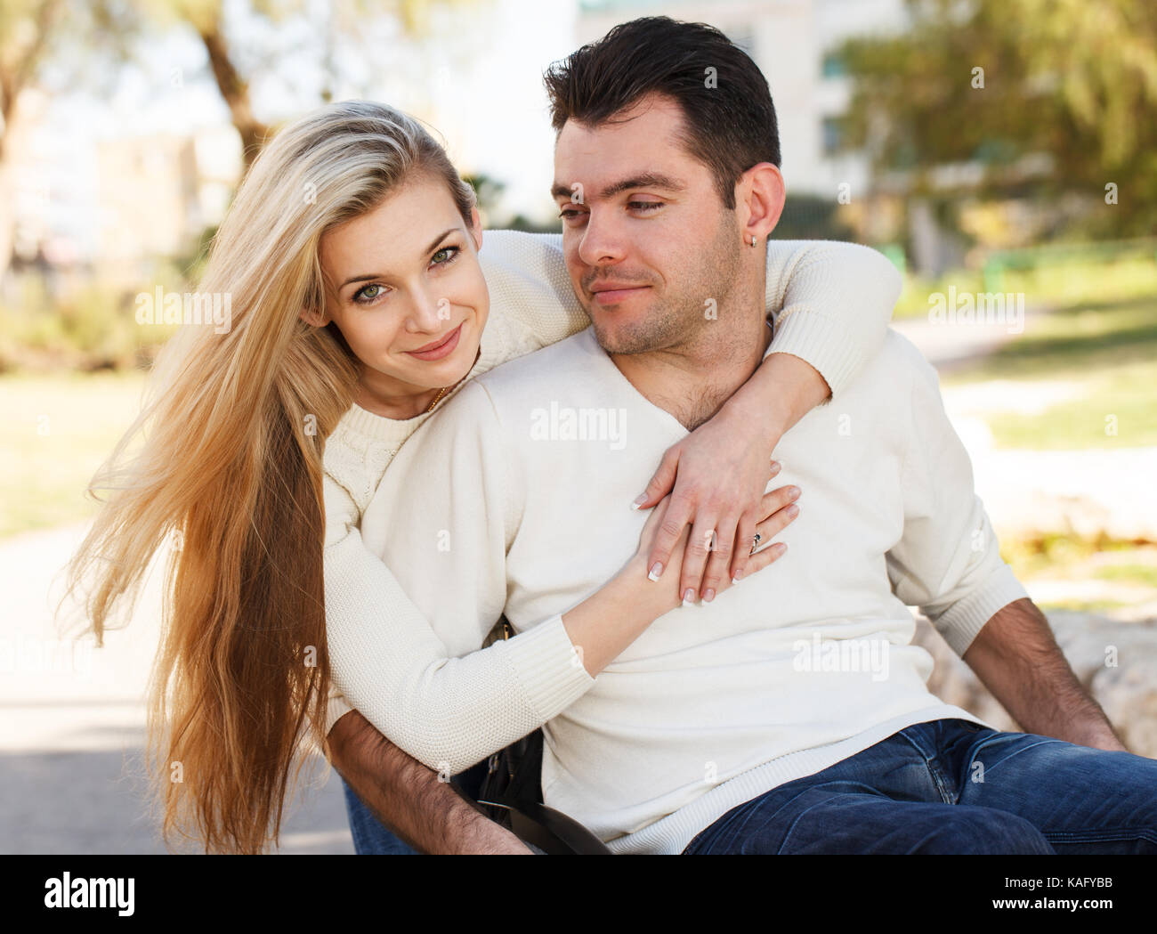 Girl hugging her boyfriend sitting on a wheelchair Stock Photo - Alamy