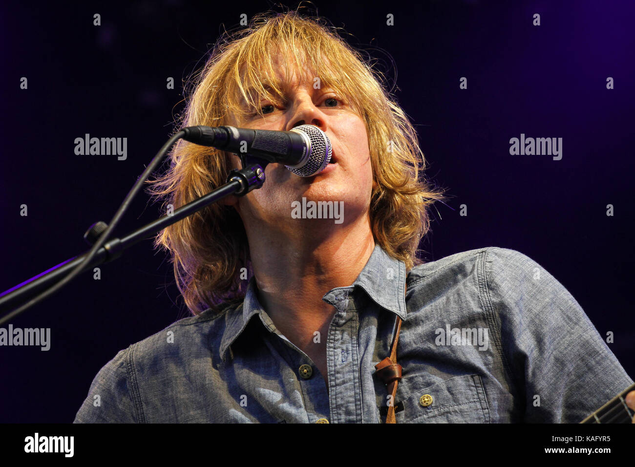 The Norwegian rock band BigBang performs a live concert at the Norwegian music festival Hovefestivalen 2012. Here band frontman, singer and musician Øystein Greni is pictured live on stage. Norway, 29/06 2012. Stock Photo