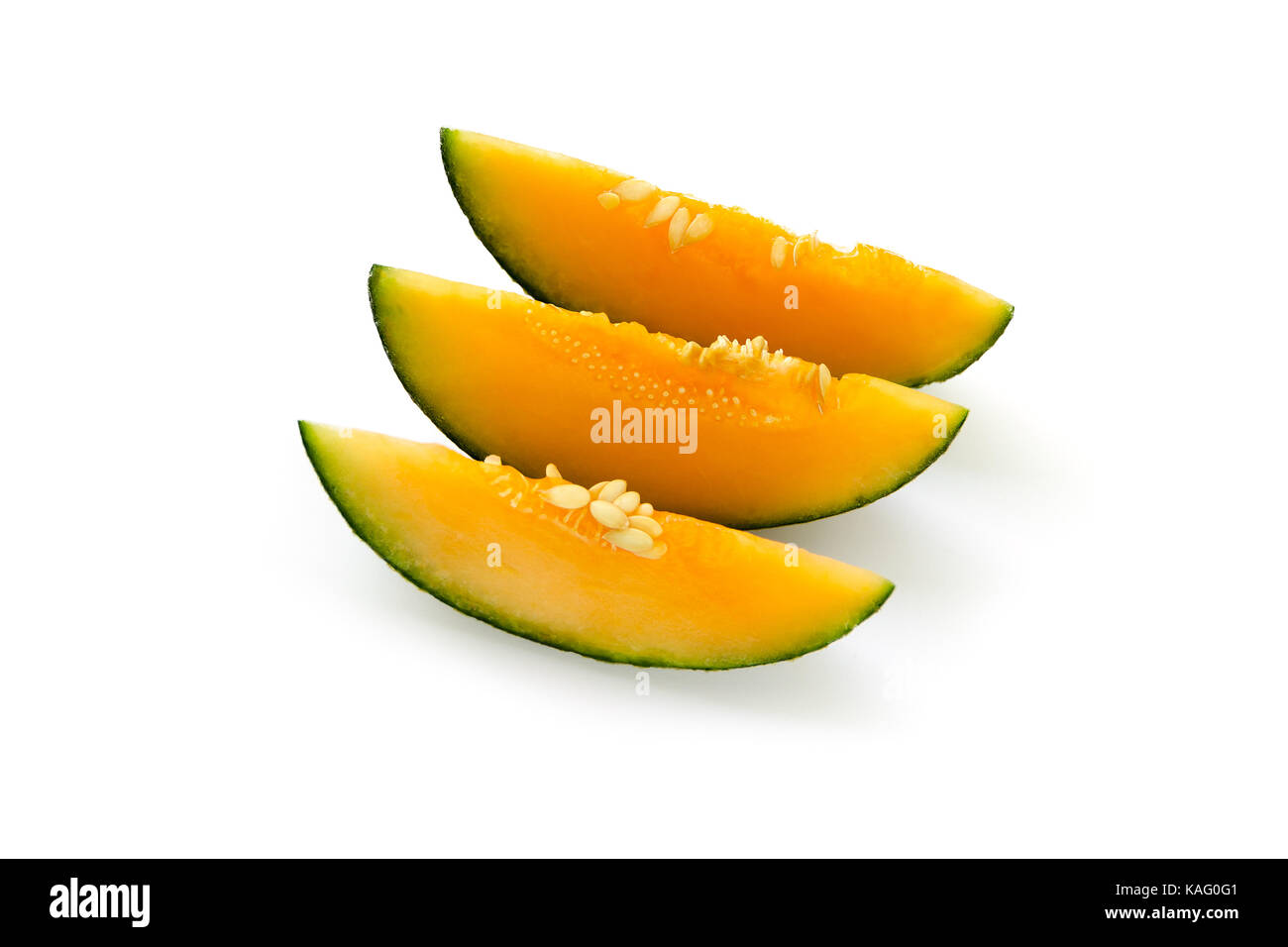 Three cut pieces of ripe yellow melon. With seeds. Isolated on white background Stock Photo