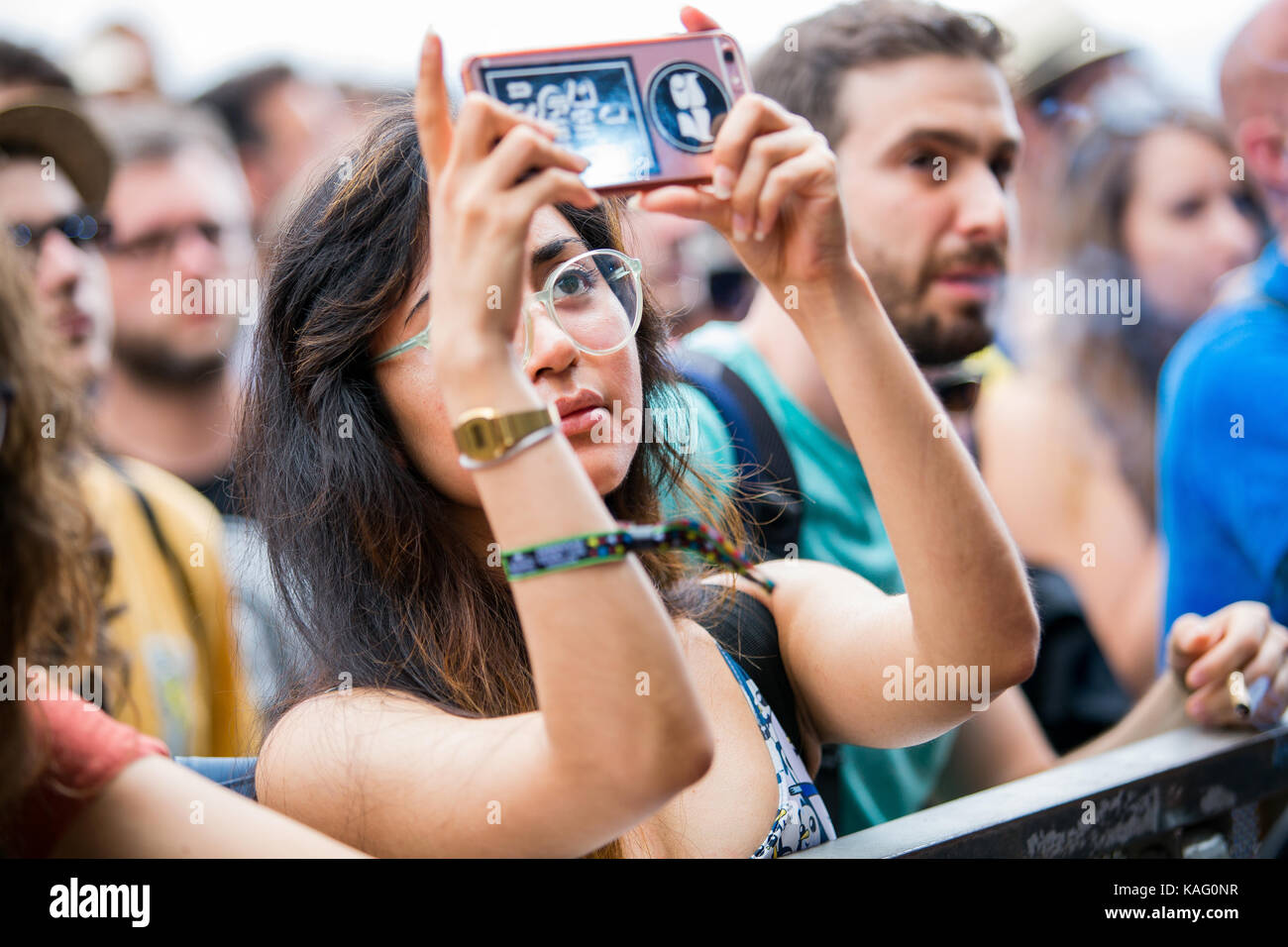 A concert-goer takes a photo with her smart phone at a live concert at the Spanish music festival Primavera Sound 2016 in Barcelona. Spain, 04/06 2016. Stock Photo