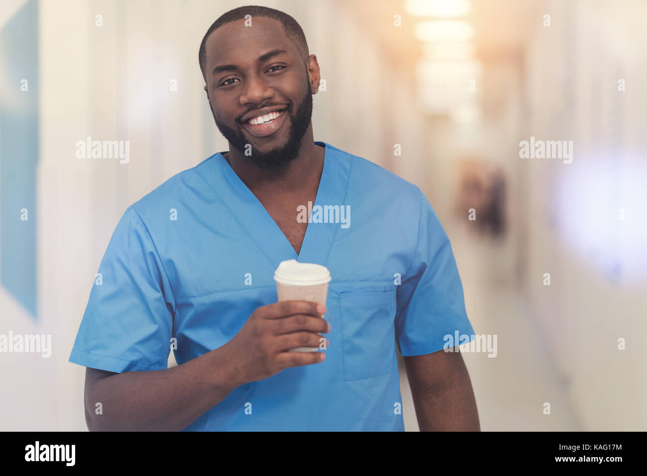 Handsome black man holding paper cup with coffee Stock Photo - Alamy