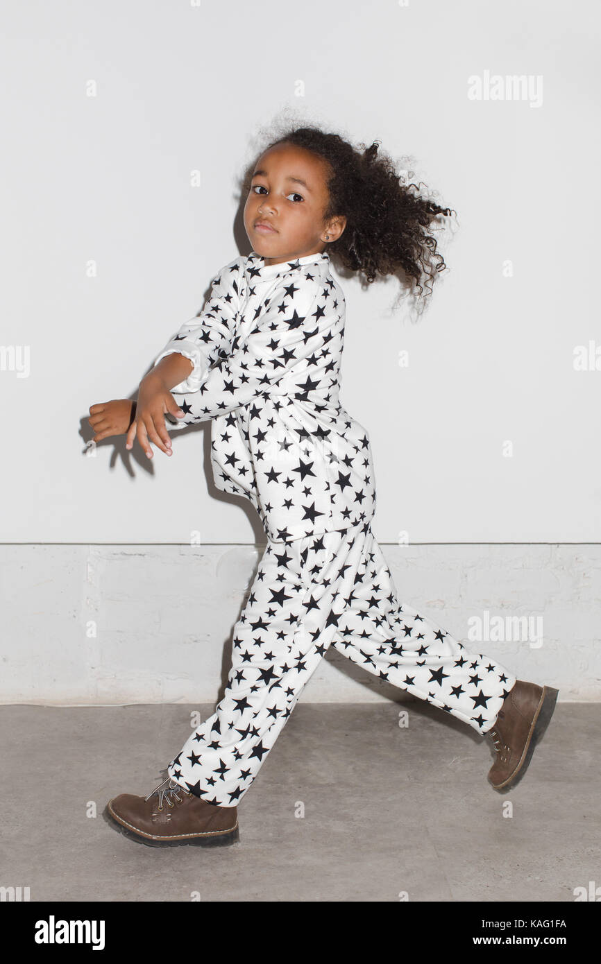 Young Girl Running In Studio on a white background Stock Photo