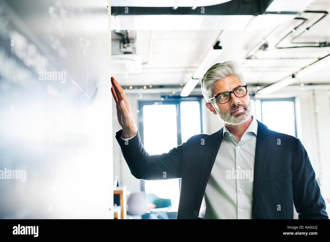 Mature businessman in suit in the office Stock Photo - Alamy