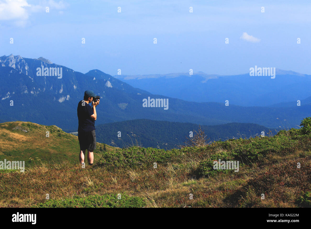 Hiker takes photos of mountains Stock Photo