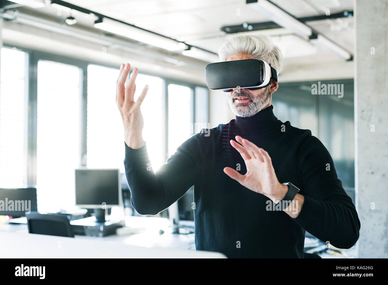 Mature businessman with VD goggles in the office Stock Photo - Alamy