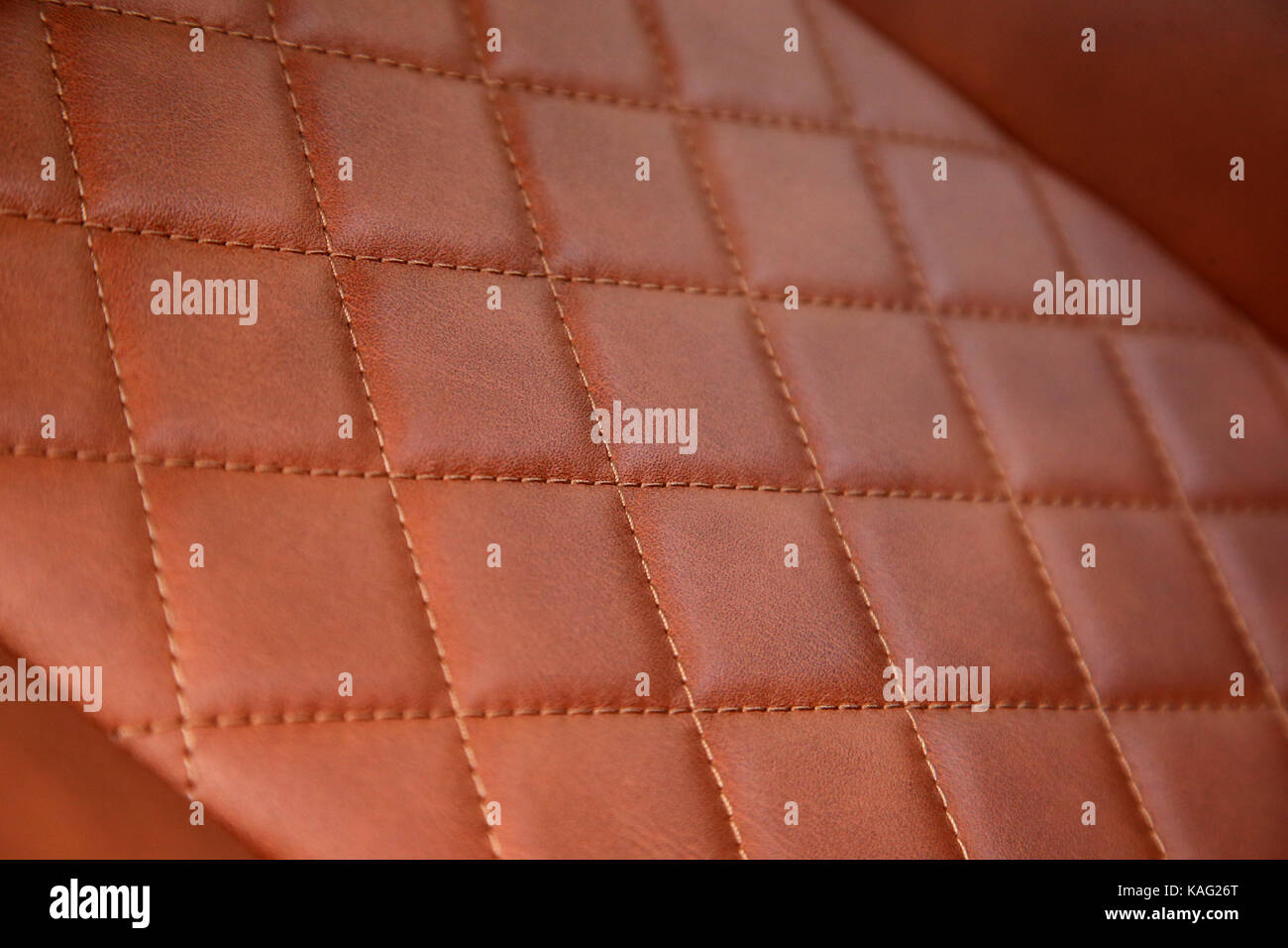 A detailed image of the tan leather and stitching of a Lamborghini Aventador seat Stock Photo