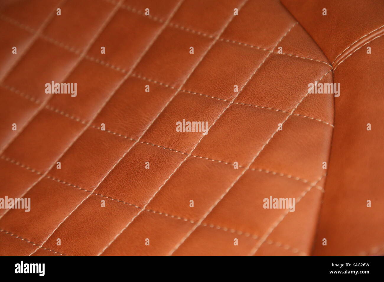 A detailed image of the tan leather and stitching of a Lamborghini Aventador seat Stock Photo