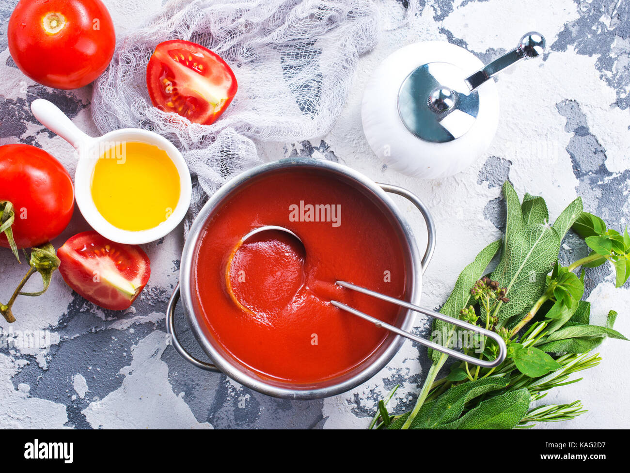 fresh tomato soup and tomato on kitchen table Stock Photo - Alamy