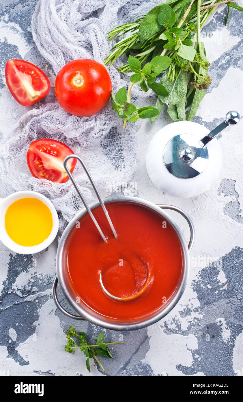 fresh tomato soup and tomato on kitchen table Stock Photo - Alamy