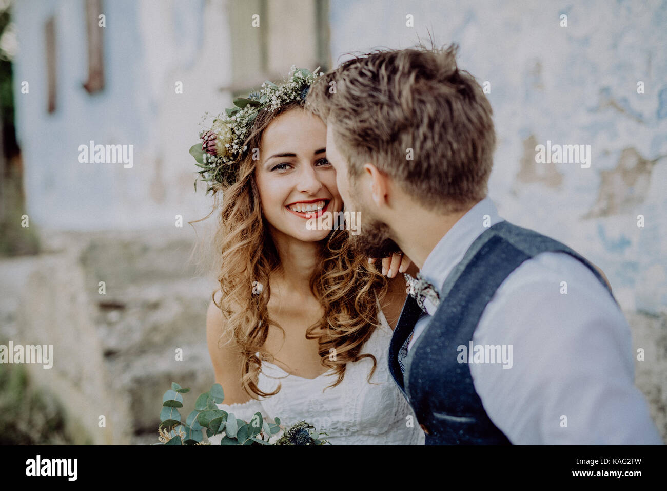 Beautiful bride and groom in front of old shabby house Stock Photo - Alamy
