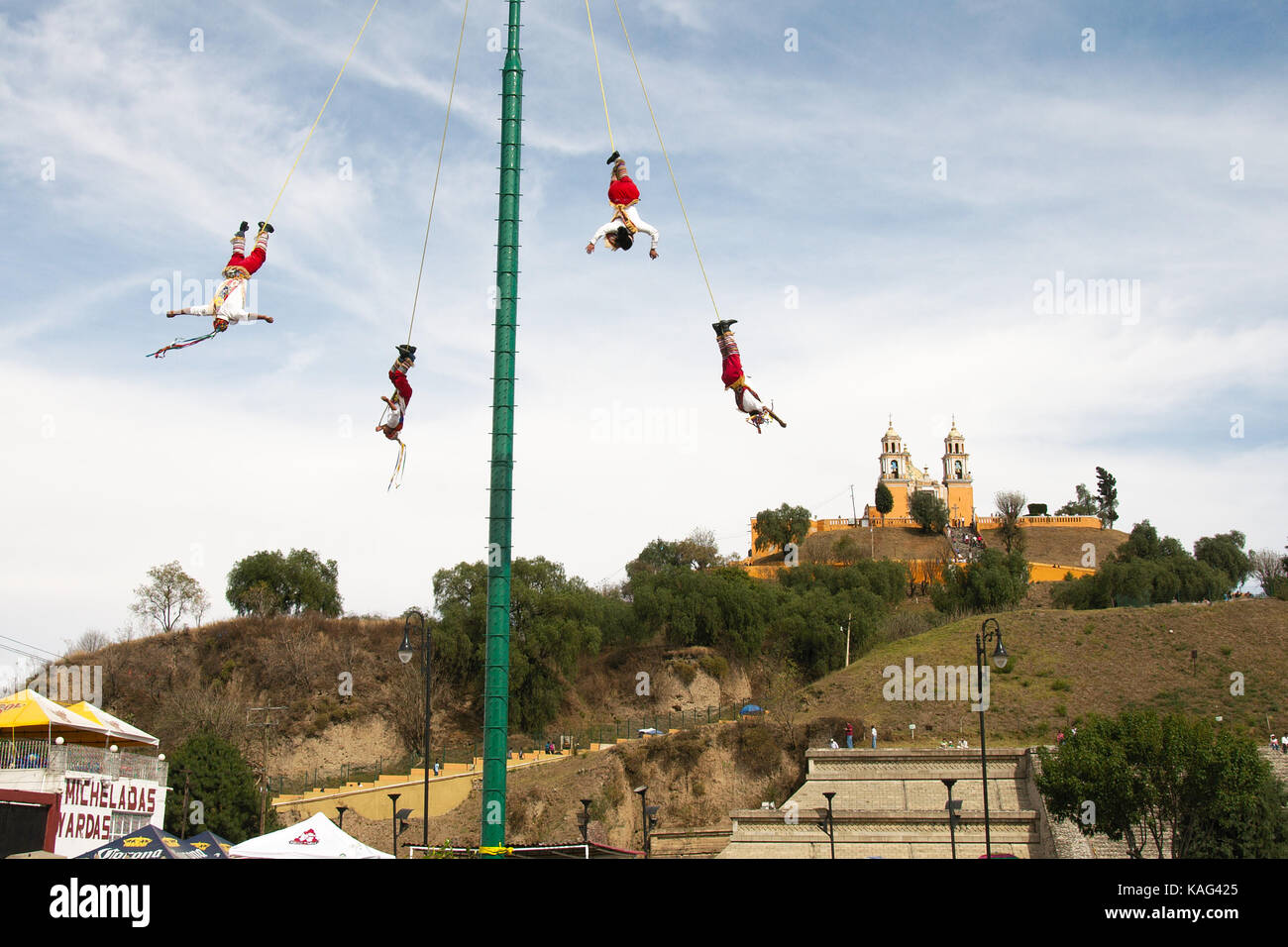 Cholula, Puebla, Mexico - 2016: Acrobats known as Los Voladores perform in font of the Great Pyramid of Cholula. Stock Photo