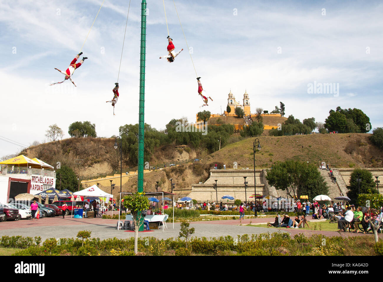 Cholula, Puebla, Mexico - 2016: Acrobats known as Los Voladores perform in font of the Great Pyramid of Cholula. Stock Photo