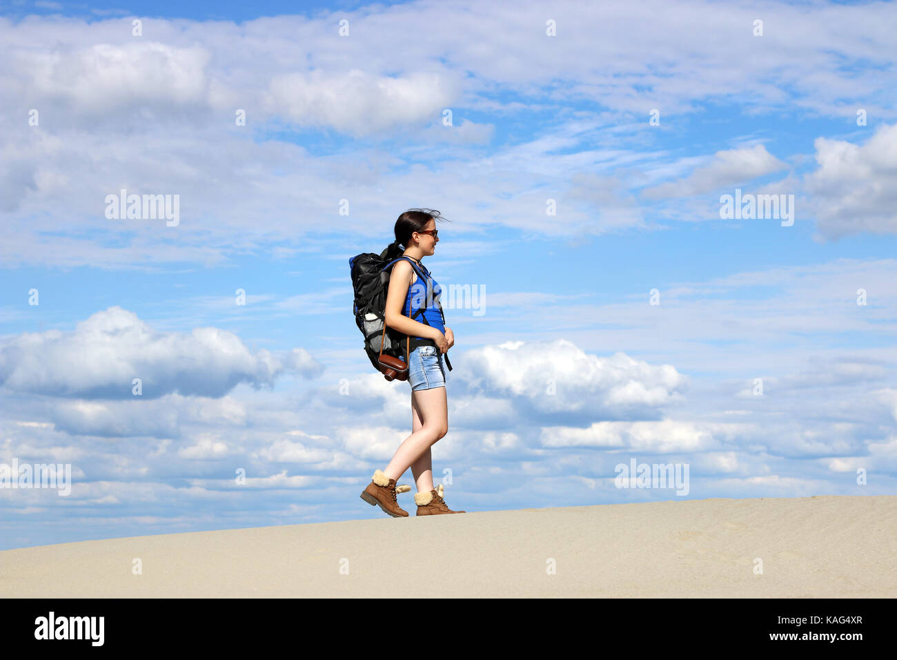 girl with backpack hiking in desert Stock Photo Alamy