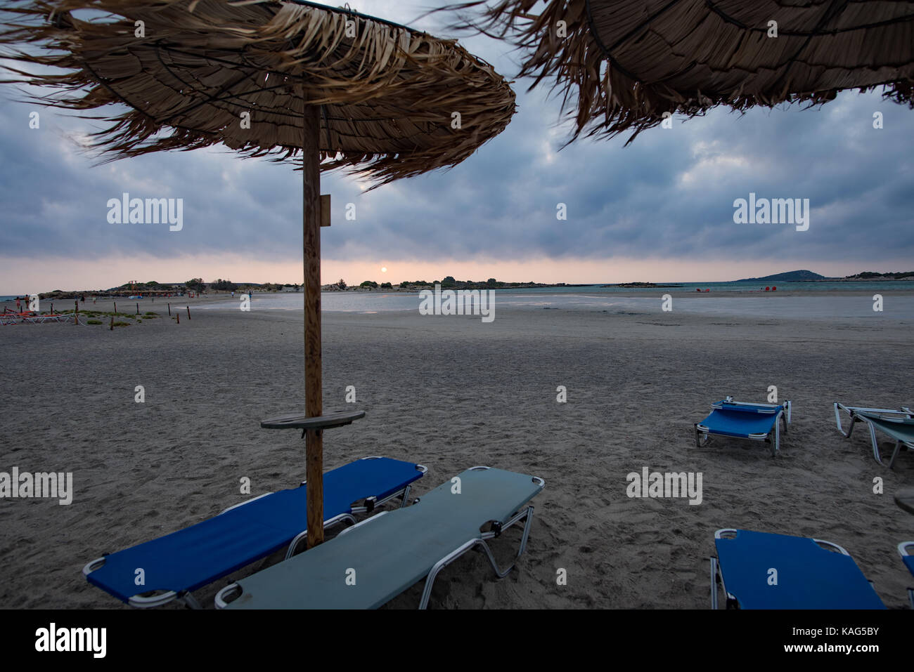 Elafonisi beach with palm ubmrellas in bad weather conditions Stock Photo