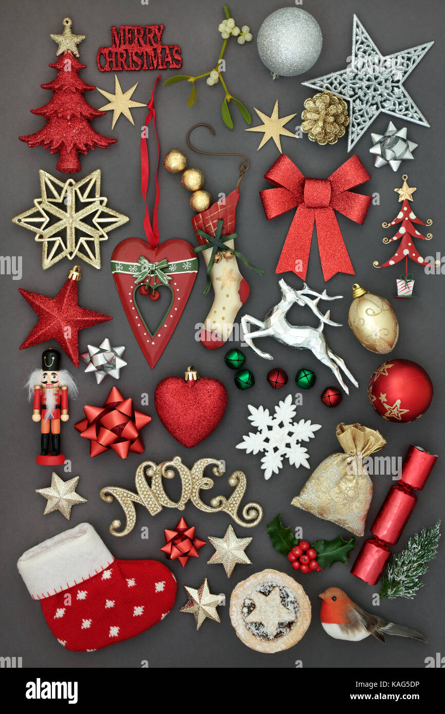 Symbols of merry christmas with new and old fashioned bauble decorations, holly, mistletoe, fir, mince pie,  and sign  on grey background. Stock Photo