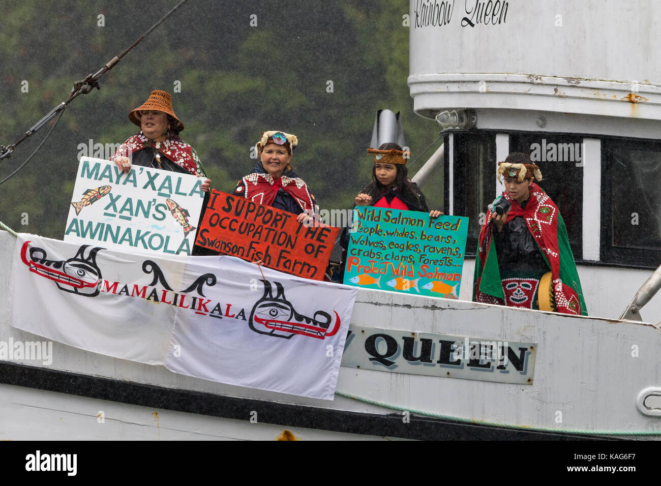 First Nations people protesting on the 'Rainbow Queen' against fish farms at Swanson Island, British Columbia, Canada. Stock Photo