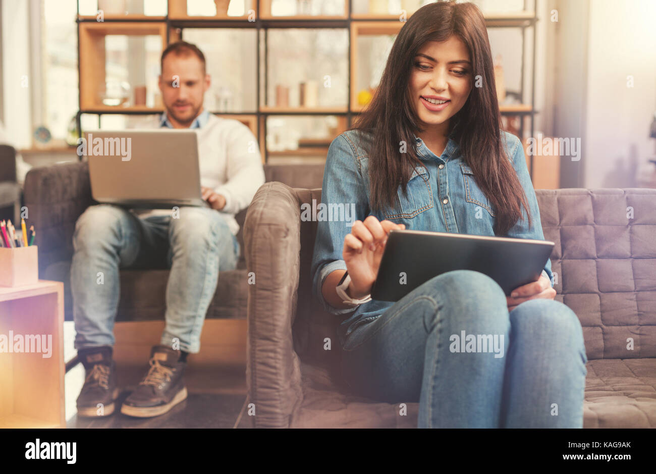 Selective focus on female freelance working on digital tablet Stock Photo