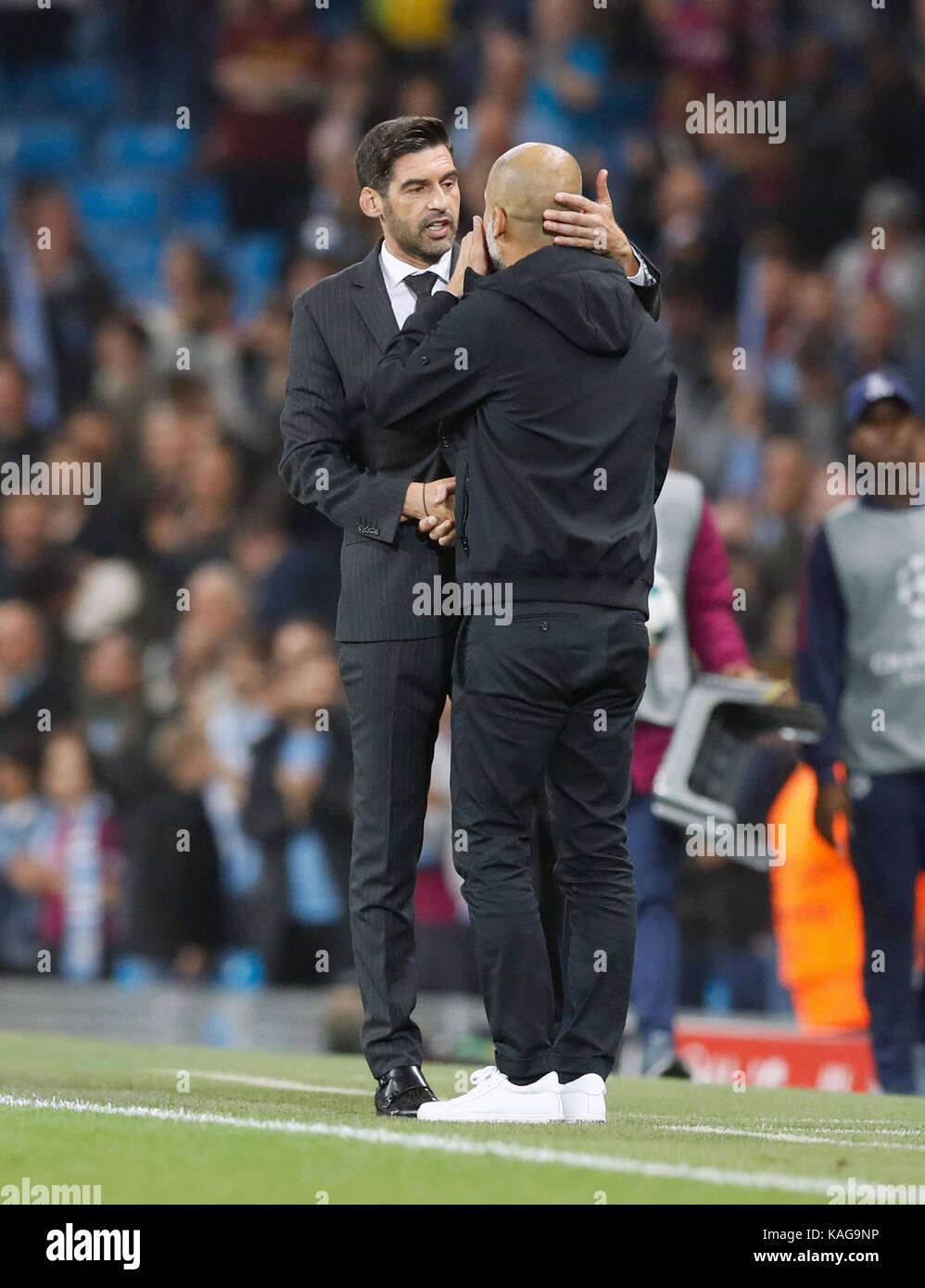 Manchester City manager Pep Guardiola (right) speaks to Shakhtar ...