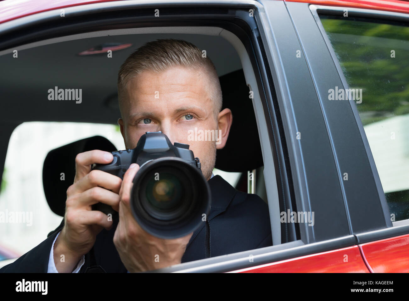 Close-up Of A Male Driver Photographing With Slr Camera From Car Stock Photo