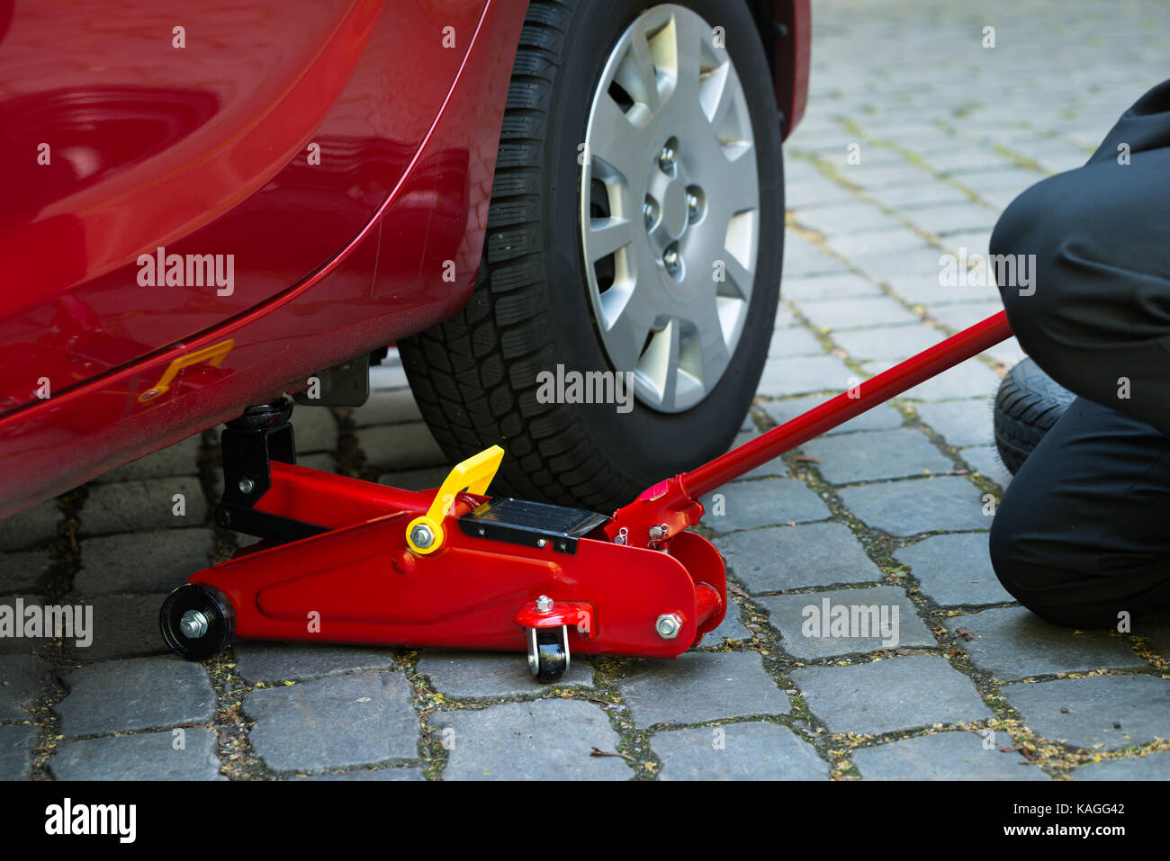 Car Lifted With Red Hydraulic Floor Jack For Repairing Stock Photo Alamy