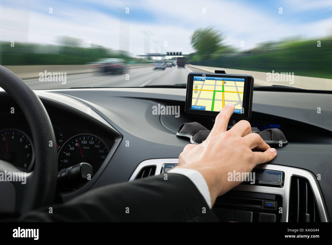 Close-up Of A Person's Hand Using Gps Navigation System In Car Stock Photo