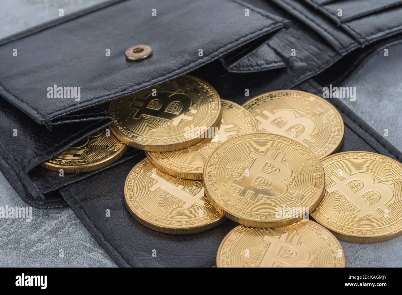 Gold Bitcoins spilling from black billfold wallet. For Bitcoin wallet,  virtual money, cryptocurrency, peer to peer transactions, Bitcoin price  crash Stock Photo - Alamy