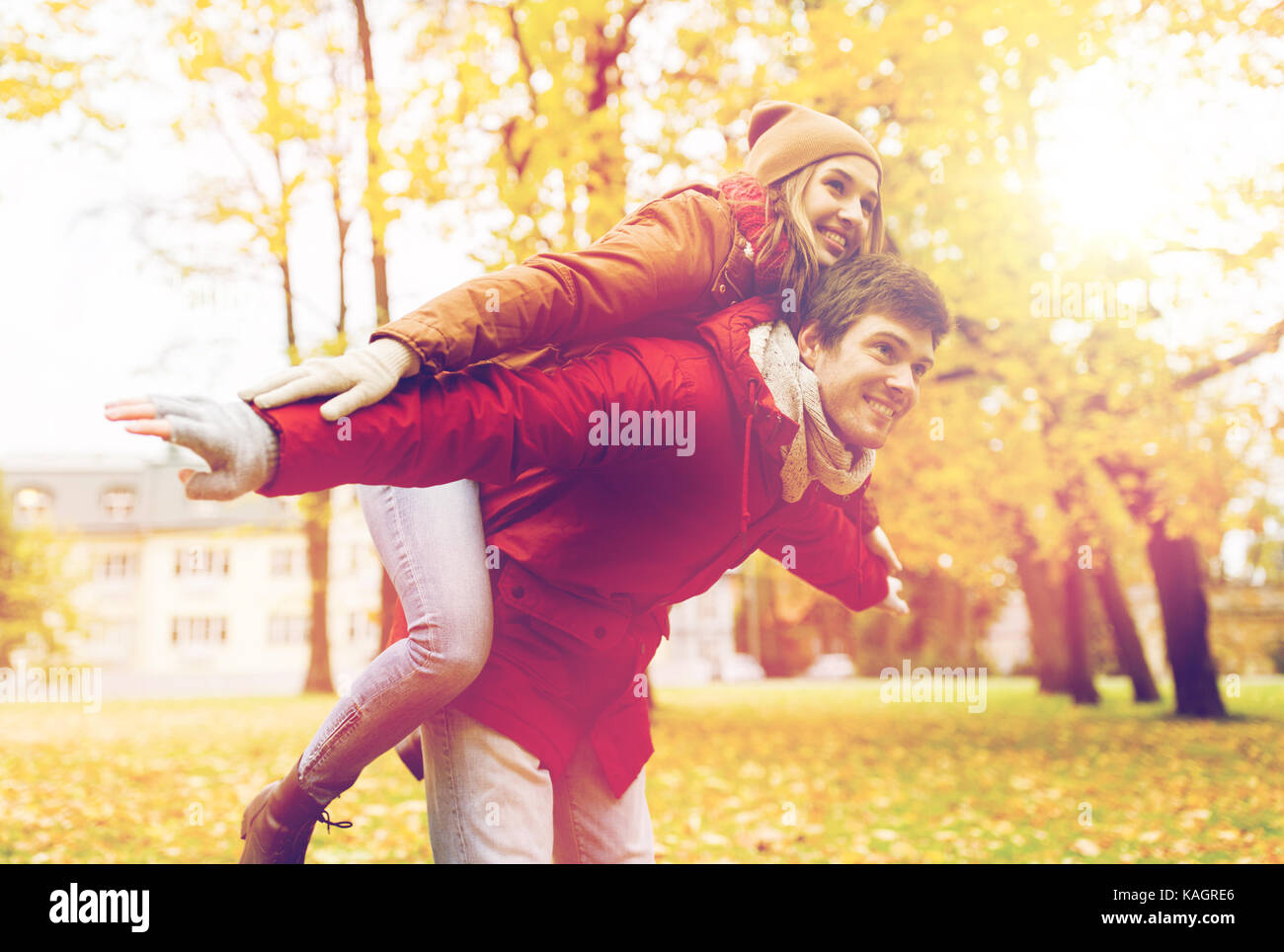 happy young couple having fun in autumn park Stock Photo - Alamy