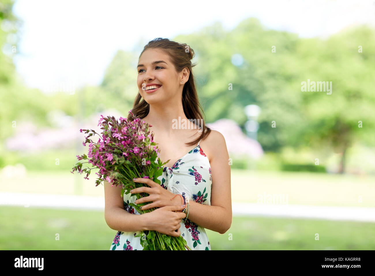 happy young woman with flowers in summer park Stock Photo - Alamy