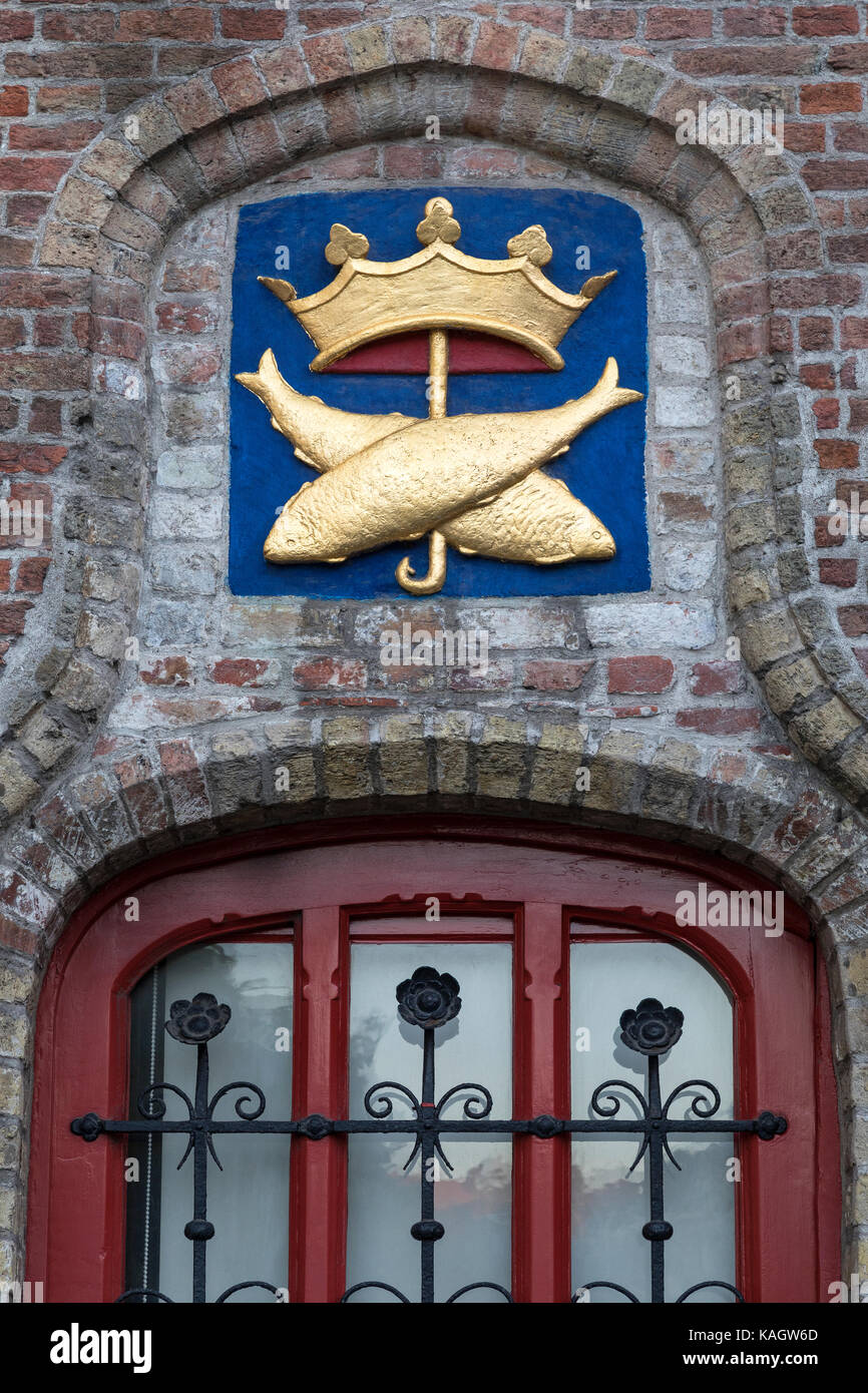 Symbol above a window at the Vismarkt (fish market) in the historic city of Bruges in Belgium. The historic city center is a UNESCO World Heritage Sit Stock Photo