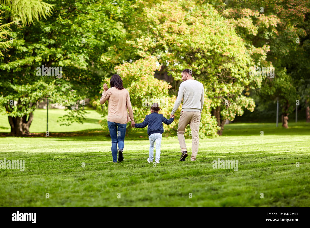 happy family walking in summer park Stock Photo - Alamy