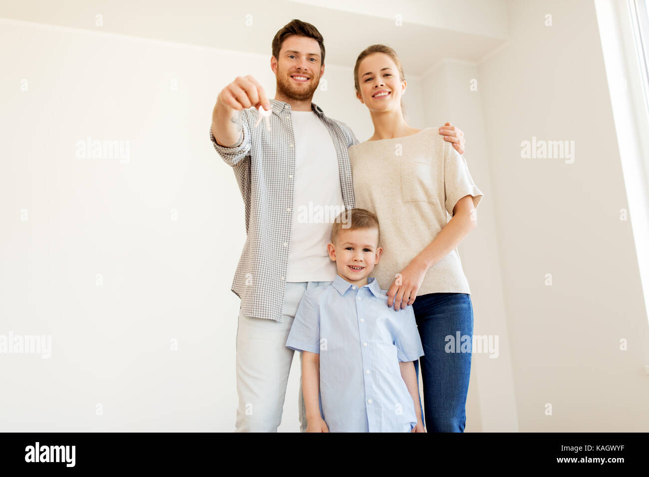 happy family with key moving to new home Stock Photo - Alamy