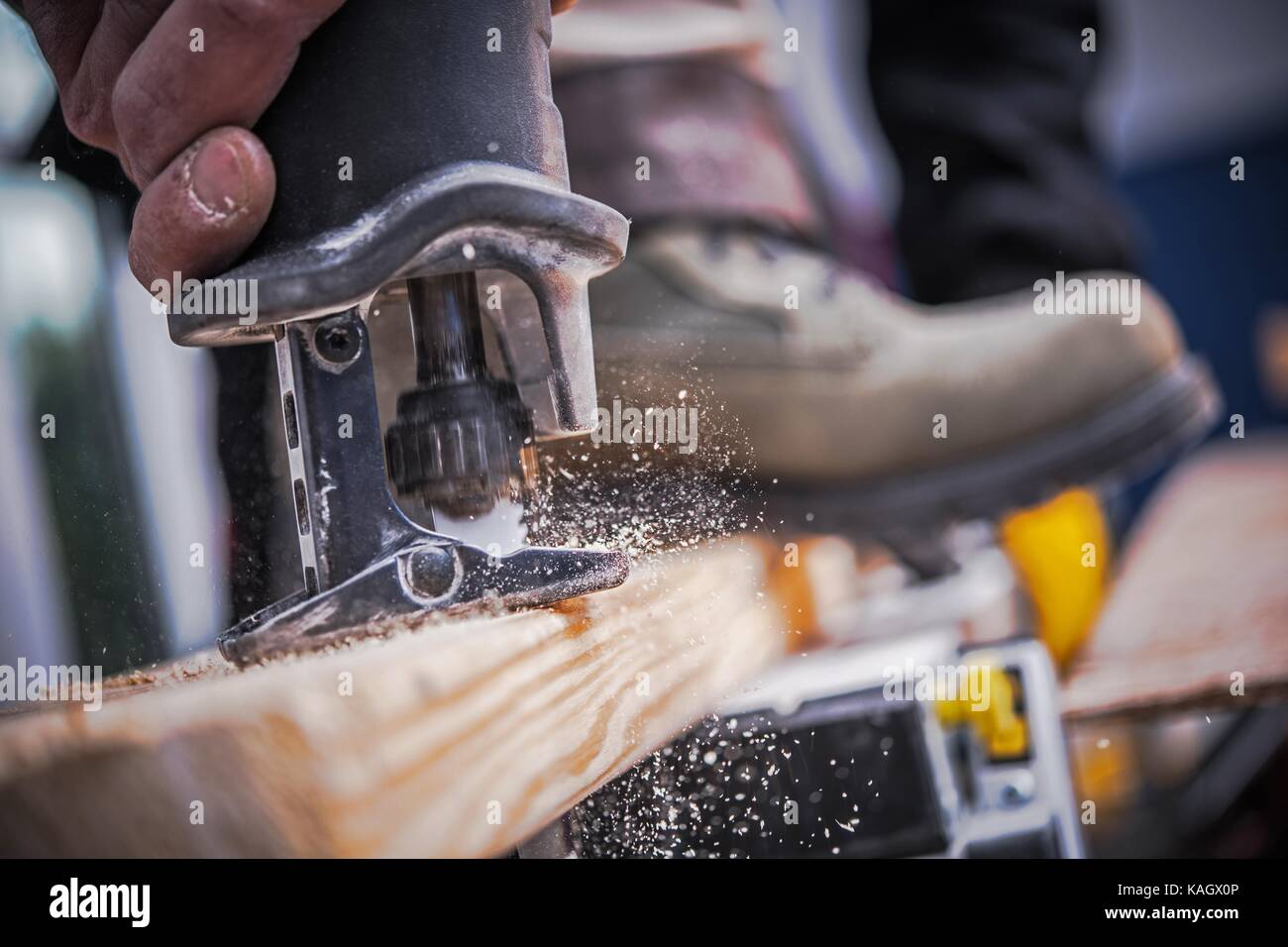 Wood Construction Power Tool. Wood Plank Cutting by Reciprocating Saw. Stock Photo