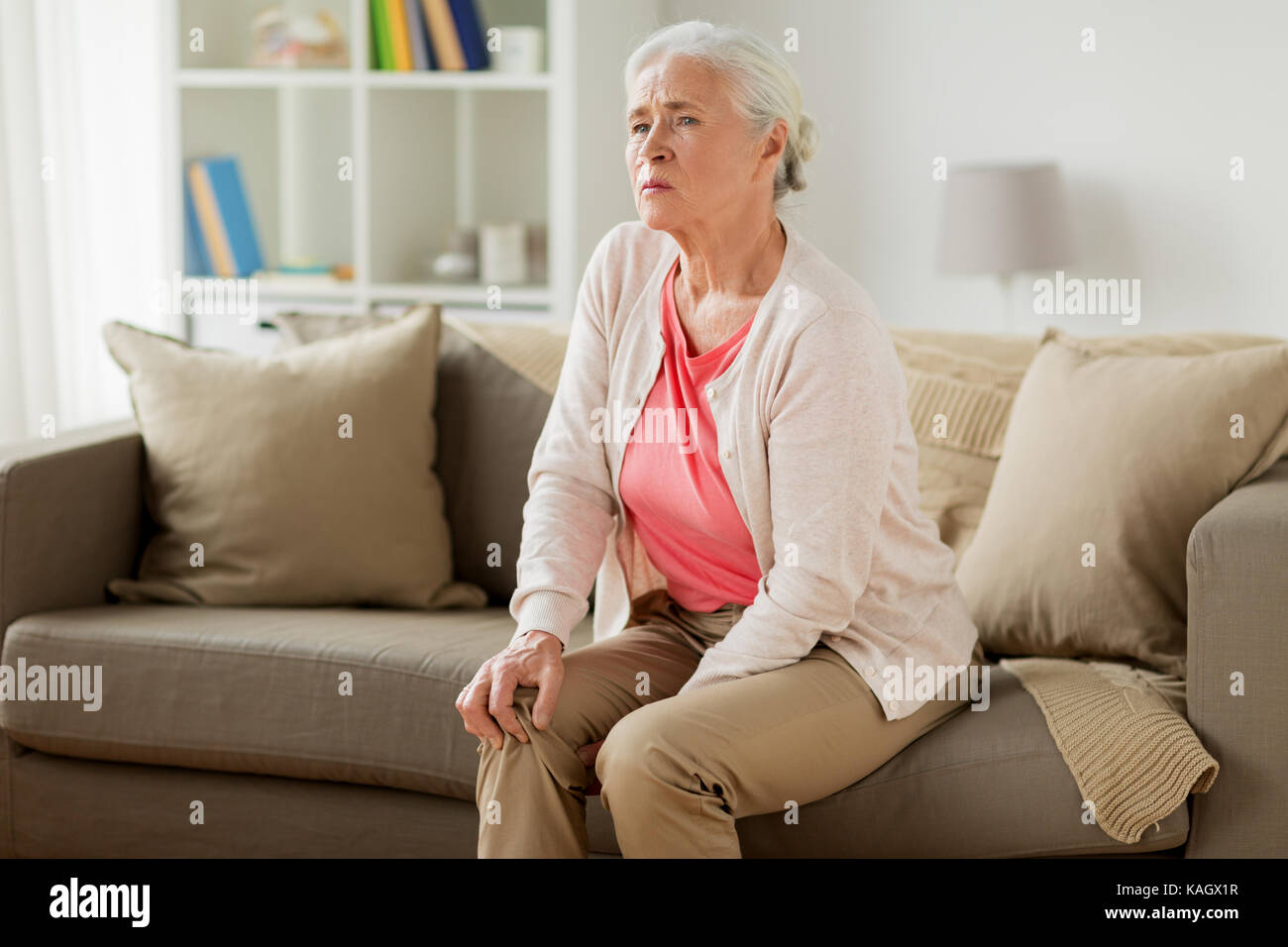 senior woman suffering from pain in leg at home Stock Photo - Alamy