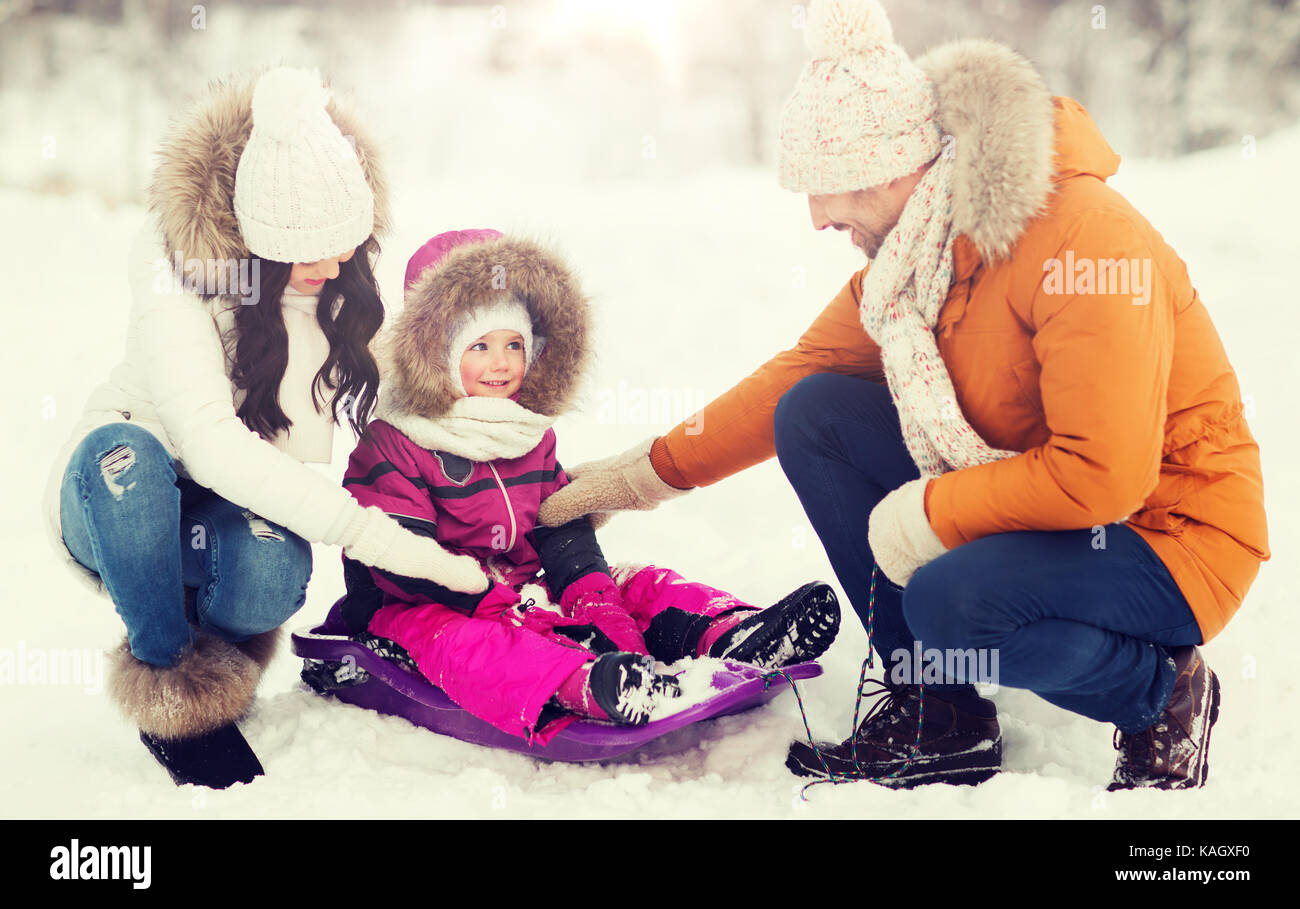 happy family with sled walking in winter forest Stock Photo - Alamy
