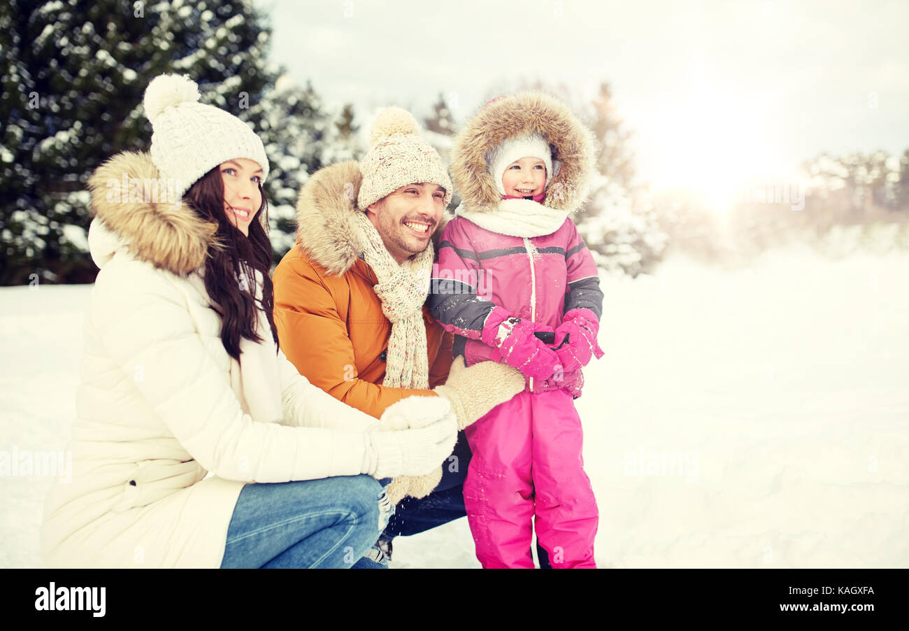 happy family with child in winter clothes outdoors Stock Photo