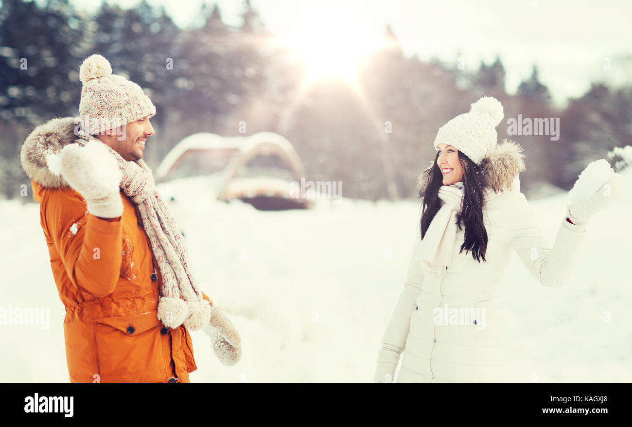 happy couple playing snowballs in winter Stock Photo - Alamy