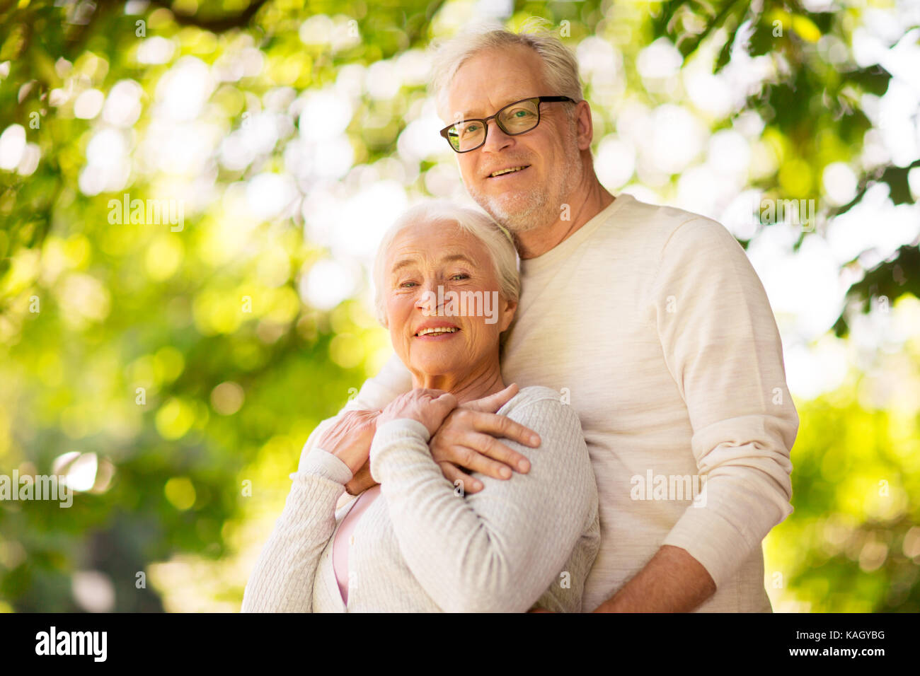 happy senior couple hugging at summer park Stock Photo - Alamy