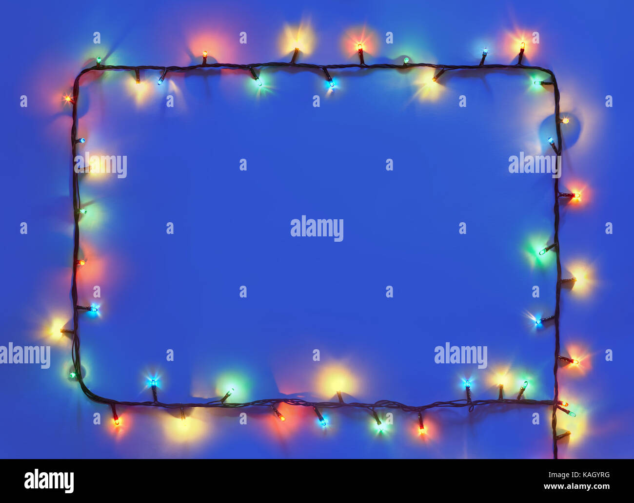 Christmas lights frame on dark blue background with copy space ...